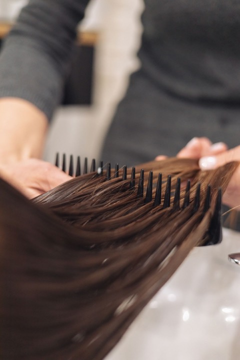 Stock close-up of hair being combed, used as editorial design reference